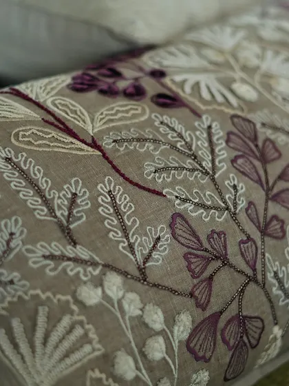 From our 'Ethereal Rose' collection, this cushion features intricate beadwork and embroidery in shades of wine and taupe. The delicate fern-like patterns add a touch of romance and sophistication.