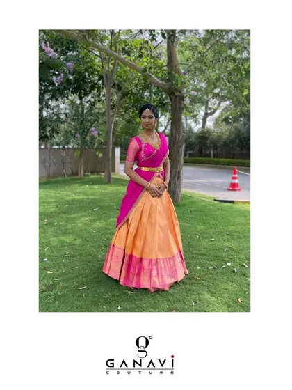 A full-length view of Shalini in her beautiful half-saree. The traditional Kanjeevaram skirt is paired with a modern embroidered blouse and a vibrant pink dupatta, creating a balanced and stylish look.