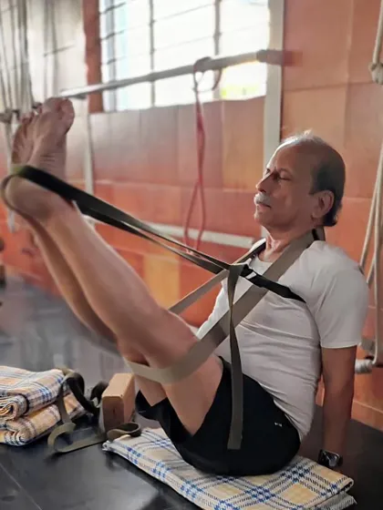A supported variation of Navasana (Boat Pose) using straps. This builds core strength and stability without straining the lower back, making it an excellent preparation for the full posture.