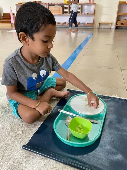 A series of images showing children engaged in food preparation. Whether it's cutting, peeling, or spooning, these activities are fundamental for developing the fine motor skills and concentration needed for writing and other complex tasks.