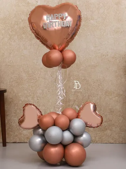 A simple and elegant balloon bouquet in rose gold and silver. This makes for a perfect gift or a standalone decorative piece for a small, intimate celebration.
