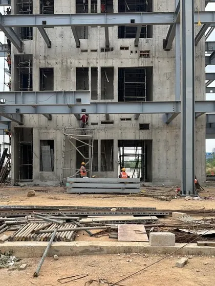 The concrete core and steel framework of the ePositive campus under construction. This view highlights the robust engineering and the layered process of building, where the foundational elements of the design become a physical reality.