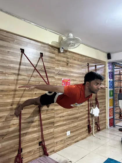 This side view showcases the perfect alignment and muscle engagement in this advanced rope pose, highlighting the strength of the entire posterior chain.