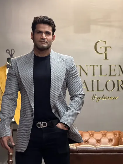 A closer view of the grey patterned blazer, showing the intricate fabric and the confident fit.