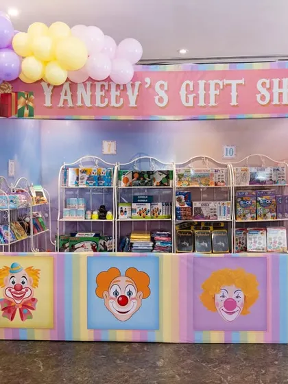 A fully stocked gift shop booth for a carnival party, allowing guests to redeem tickets for prizes.