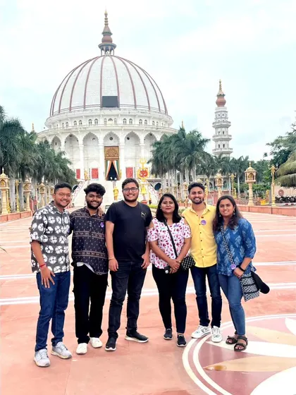 The group posing in front of the magnificent MIT World Peace Dome in Pune.