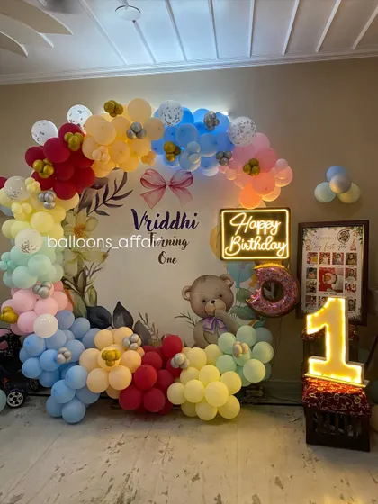 Another angle of the teddy bear first birthday setup, showing the placement of the light-up number and photo frame.