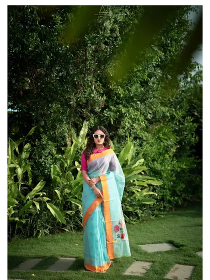 A classic, full-length fashion pose. This image clearly displays the entire saree, from the drape to the floral embroidery, making it an ideal shot for a brand's lookbook or catalogue.