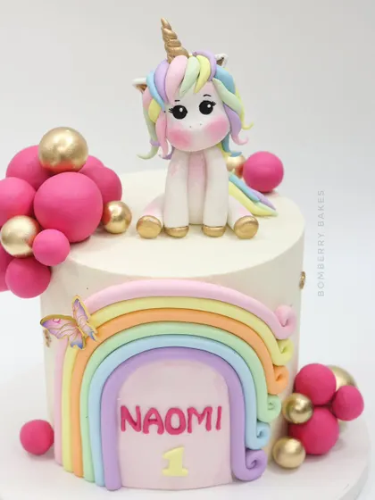 A dreamy unicorn and rainbow cake for a first birthday. I teach how to create this adorable pastel unicorn topper and the multi-colored rainbow arch.