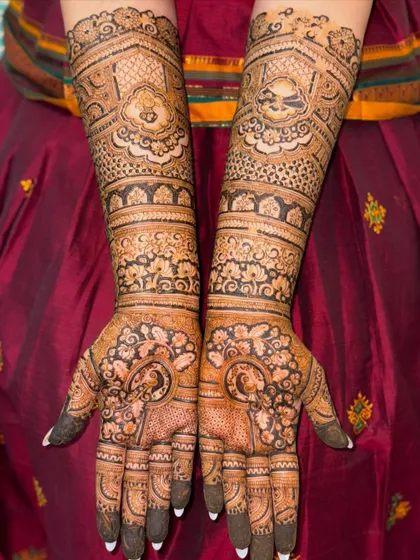 This full-arm bridal mehendi showcases a variety of patterns, from florals to paisleys. The dark, consistent application ensures a beautiful stain and a design that looks stunning from every angle.