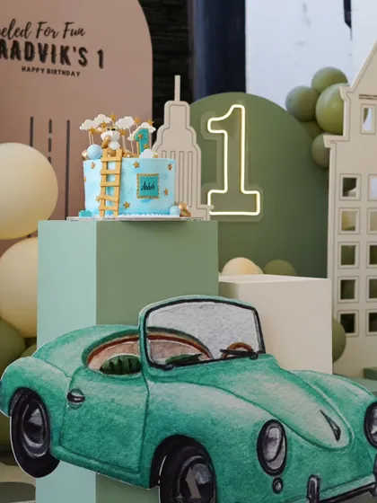 A close-up of a vintage car themed first birthday. The "Fueled for Fun" tagline, city skyline cutouts, and a classic car prop create a cool and stylish theme for a little one's milestone.