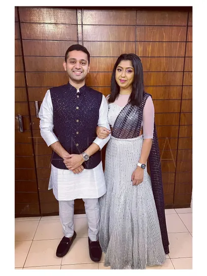 The happy couple again, showing how a coordinated embellished Bundi jacket and a glitter net lehenga create a perfect pair for any wedding event.