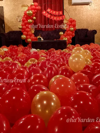 A room filled with red and gold balloons for the ultimate romantic surprise. I can turn any room into a sea of balloons for your loved one.