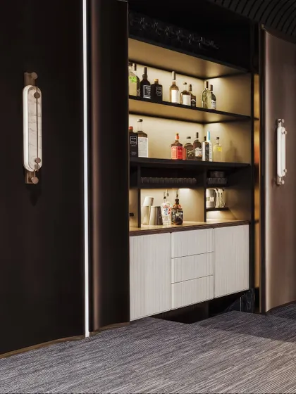 This render reveals a hidden bar cabinet within the entertainment room, complete with backlit shelves to showcase a collection of spirits.