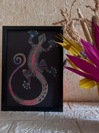 The completed lizard stippling art, framed and displayed as home decor.