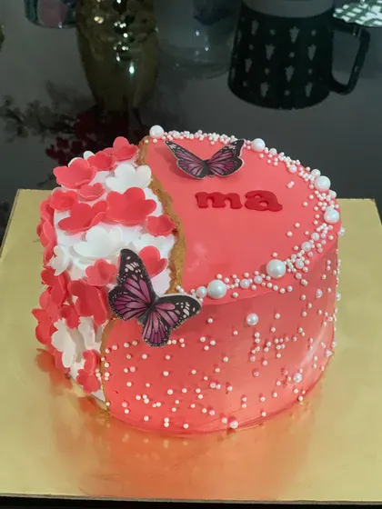 A modern fault-line cake for "Ma". The design features a cascade of red and white hearts and is topped with butterflies.