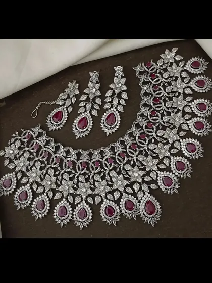 The same stunning CZ floral necklace set, but with deep ruby-red stones. You can rent this to match your outfit perfectly.