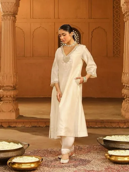 A classic ivory kurta set with delicate silver embroidery, a timeless and elegant choice for any festive occasion.