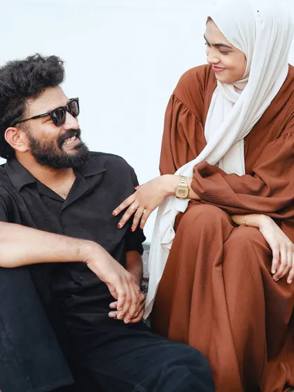 A relaxed moment between the couple as they sit and chat, with genuine smiles and easy chemistry.