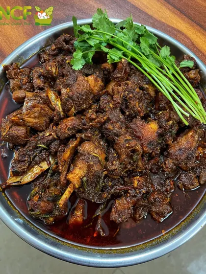 A rich and dark 'Nganu' (duck) curry, cooked Manipuri style. The duck is slow-cooked with spices until the meat is tender and flavorful.