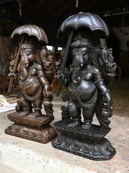 Both Umbrella Ganapathy statues are shown together to highlight the subtle differences in their finish and presence.