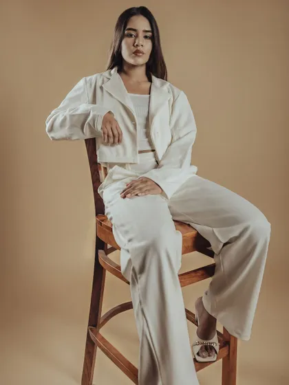 A full-length shot from a minimalist editorial shoot. This demonstrates the importance of clean, precise makeup that complements a modern aesthetic.