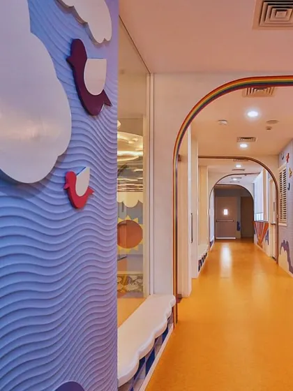 The corridor at Supaksha is an extension of the learning environment, with textured wave walls and colorful flooring. We designed the transitional spaces to be just as engaging as the classrooms themselves.