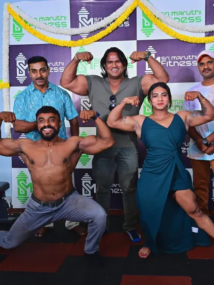 Posing with other athletes at the gym opening. It's all about celebrating strength and supporting each other.
