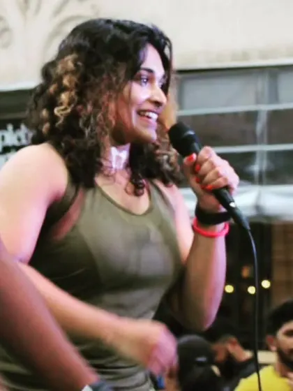 You deserve your own love and affection. A candid shot of me on the mic, smiling and connecting with the crowd.