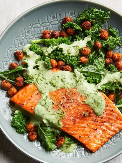 A perfectly cooked salmon fillet on a bed of fresh kale and roasted chickpeas, topped with a creamy dill sauce. This is an example of my premium non-vegetarian meals, rich in Omega-3s and designed for clean eating.