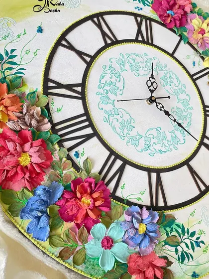 A slightly different angle of the 20-inch clock, showing the full composition. The flowers are arranged in two main clusters, creating a beautiful frame for the clock face.