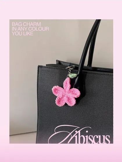 Here’s how the pink hibiscus charm looks on a classic black tote bag. I can make these in any color to match your personal style or your favorite bag.