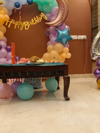 Another angle of the moon and stars home birthday decor. The setup includes a large number '4' foil balloon, making it clear what milestone is being celebrated.