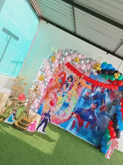 An overhead shot of the combined Princess and Avengers theme for a Children's Day celebration, showing the full scope of the setup on the green turf.