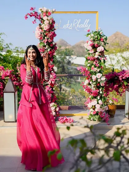 Our gorgeous bride, perfectly matching the vibrant pink decor of her mehendi celebration.