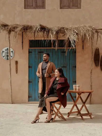 A stylish, editorial shot from a Dubai-themed set, featuring a couple enjoying a coffee date.