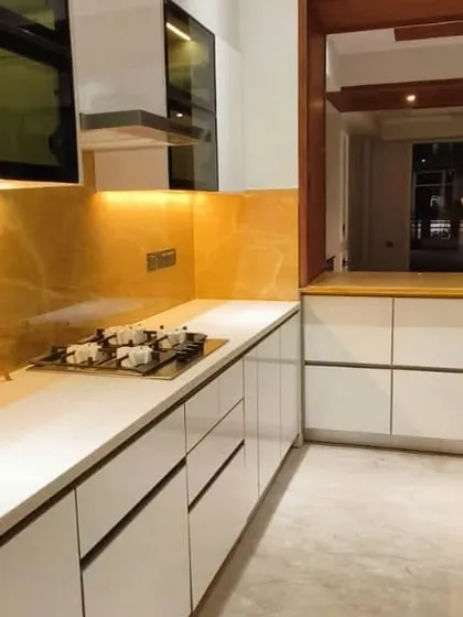 A closer look at the seamless integration of the cooktop and countertop. The handleless drawers and cabinets maintain a clean, minimalist aesthetic while providing ample storage.