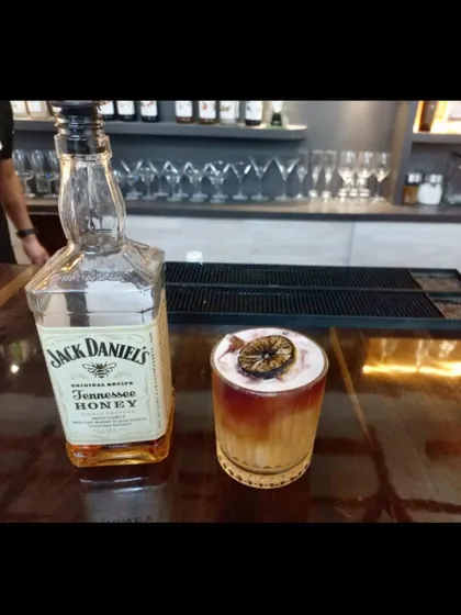 A perfectly crafted whiskey sour, a timeless classic that we masterfully prepare for any event.