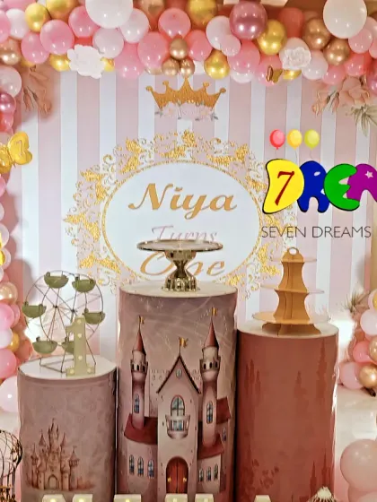 A beautiful Rapunzel and Sleeping Beauty princess party. I used a pink and gold color scheme with striped backdrops, castle-themed cake stands, and character cutouts to create this royal setup.