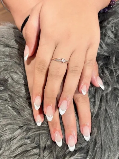 You can never go wrong with the classics. Here is a perfectly executed traditional white French manicure on elegant, almond-shaped nails.