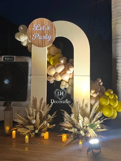 A straight-on shot of the chic party arch, showcasing the balance between the modern structure and the organic feel of the balloons and dried florals.
