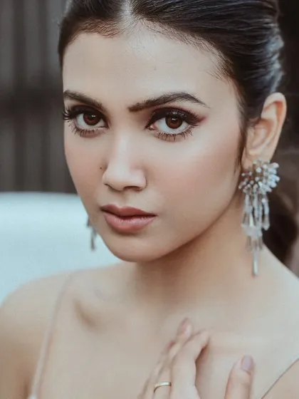 A beautiful close-up of actress Rajnandini Paul for a Sananda magazine shoot. The soft lighting highlights her delicate features and the sparkling earrings, creating an elegant and polished portrait.