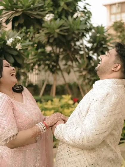 A candid moment of pure laughter between the couple during their engagement shoot.