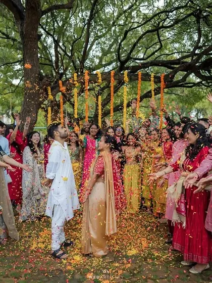 A moment of pure celebration as guests shower the couple with flowers. We design spaces that encourage joy and participation.