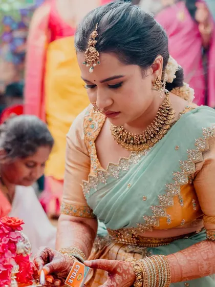 A candid shot during the wedding rituals. The makeup is designed to be resilient and look perfect from every angle, even in close-up, unposed moments.