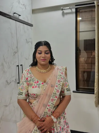 For her sister's engagement, she chose this beautiful floral lehenga. We styled her with a soft, natural makeup look.