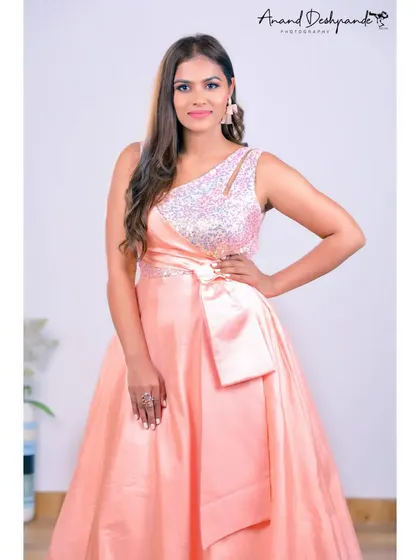 This peach ball gown is perfect for feeling like a princess. It has a sequined one-shoulder bodice and a large satin bow at the waist for a classic, elegant look.