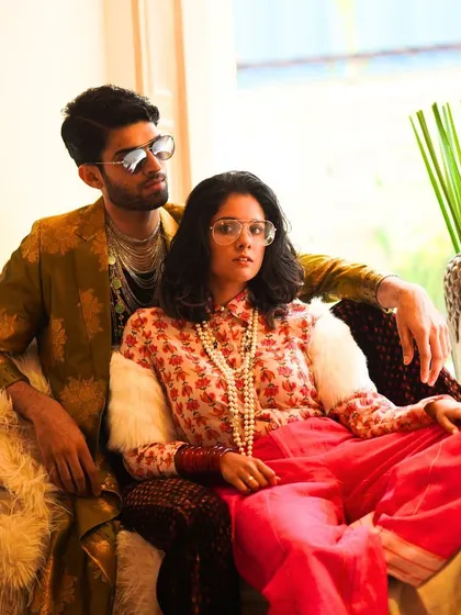 When Milan meets Paris in Mumbai. This shot captures a fusion of styles, with a modern brocade jacket for him and a floral mulmul shirt with bright pants for her. It's all about creating a vibe.