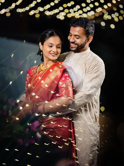 A creative portrait using fairy lights to frame the couple, adding a magical touch to their engagement photo.