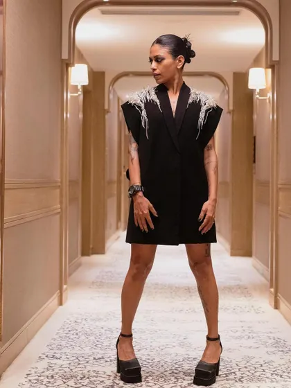 Anasuya Sengupta in a powerful stance, showcasing her full Gaurav Gupta look. The architectural hallway provides a perfect, symmetrical backdrop for this fashion-forward portrait.